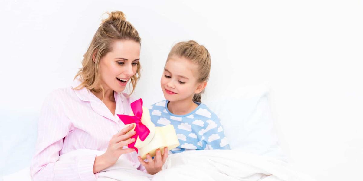 Photo of a mother receiving a gift from her kid