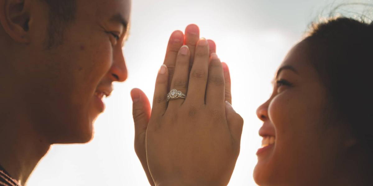 Picture of a couple wearing engagement rings