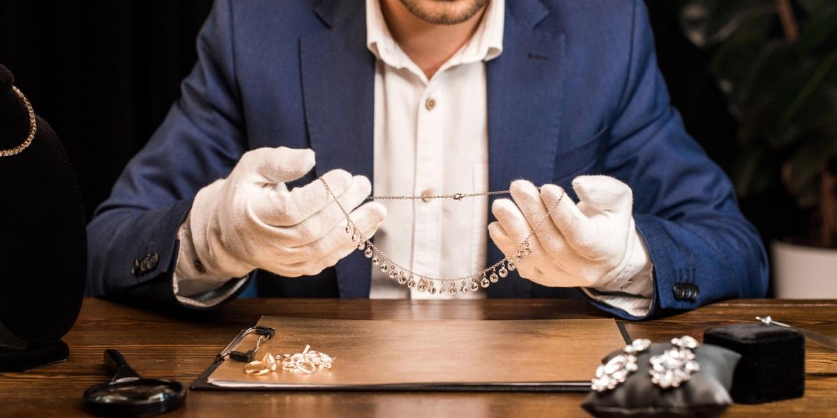 A jeweller showing a gold and diamond necklace.