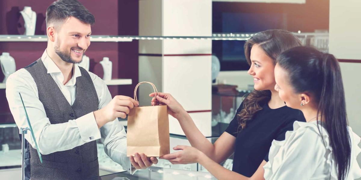 Photo of two girls buying jewellery for their mom